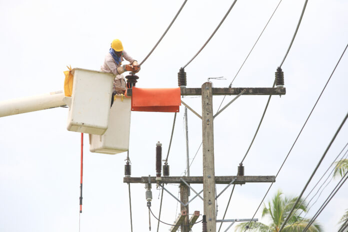 Electrician,Stays,On,The,Tower,Pole,And,Repairs,A,Wire